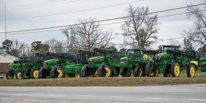 Row of farm equipment near road
