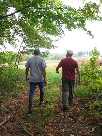 Two men walking in woods